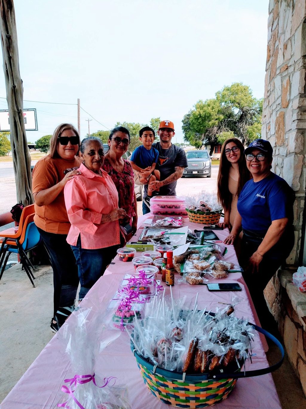 Church members running a bake sale table outside the church