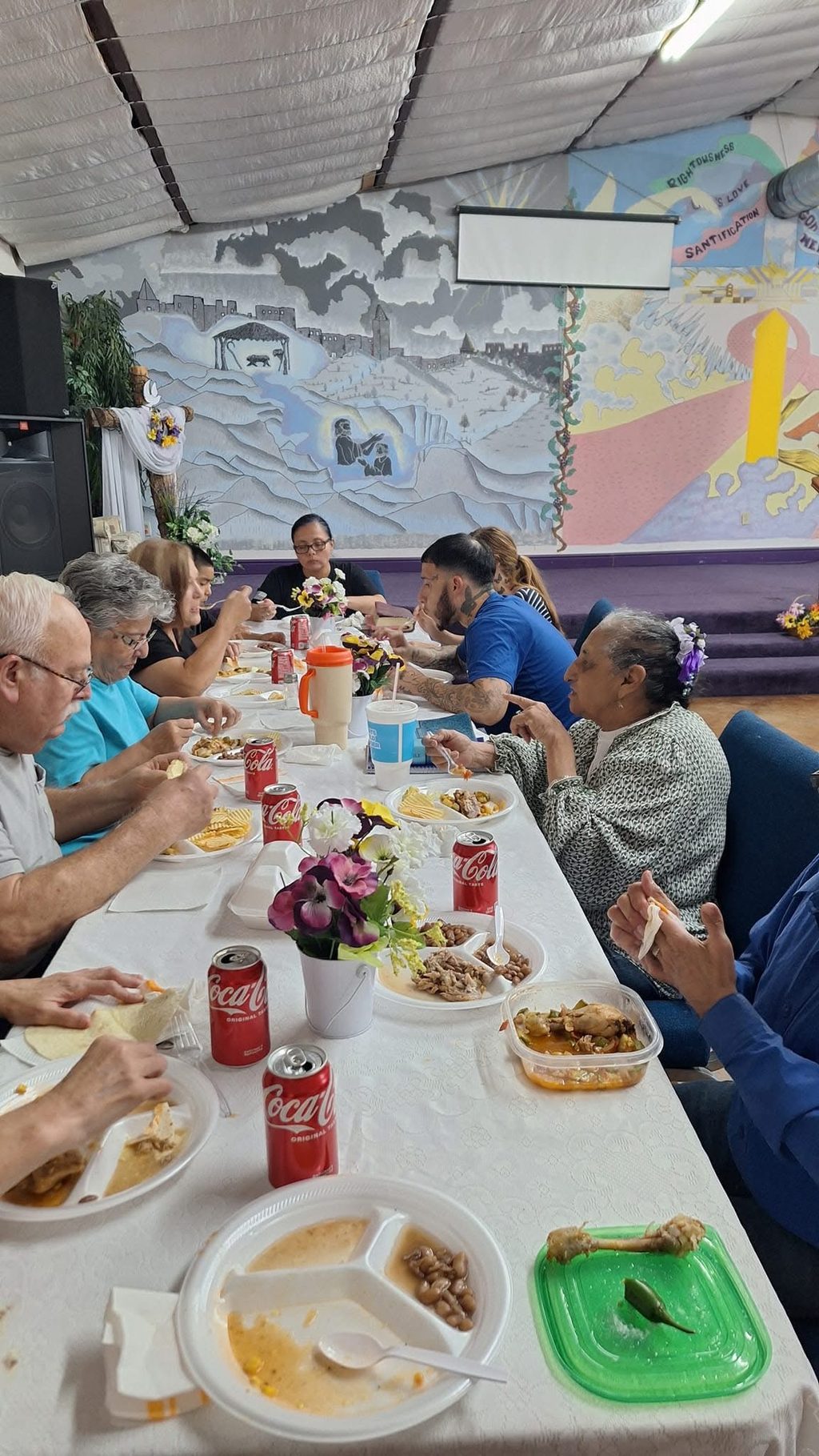 Church members sharing a meal together around a long table