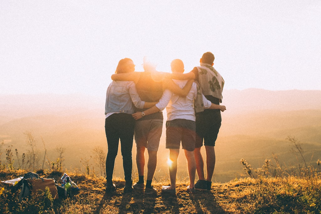 Friends gathered together at sunset