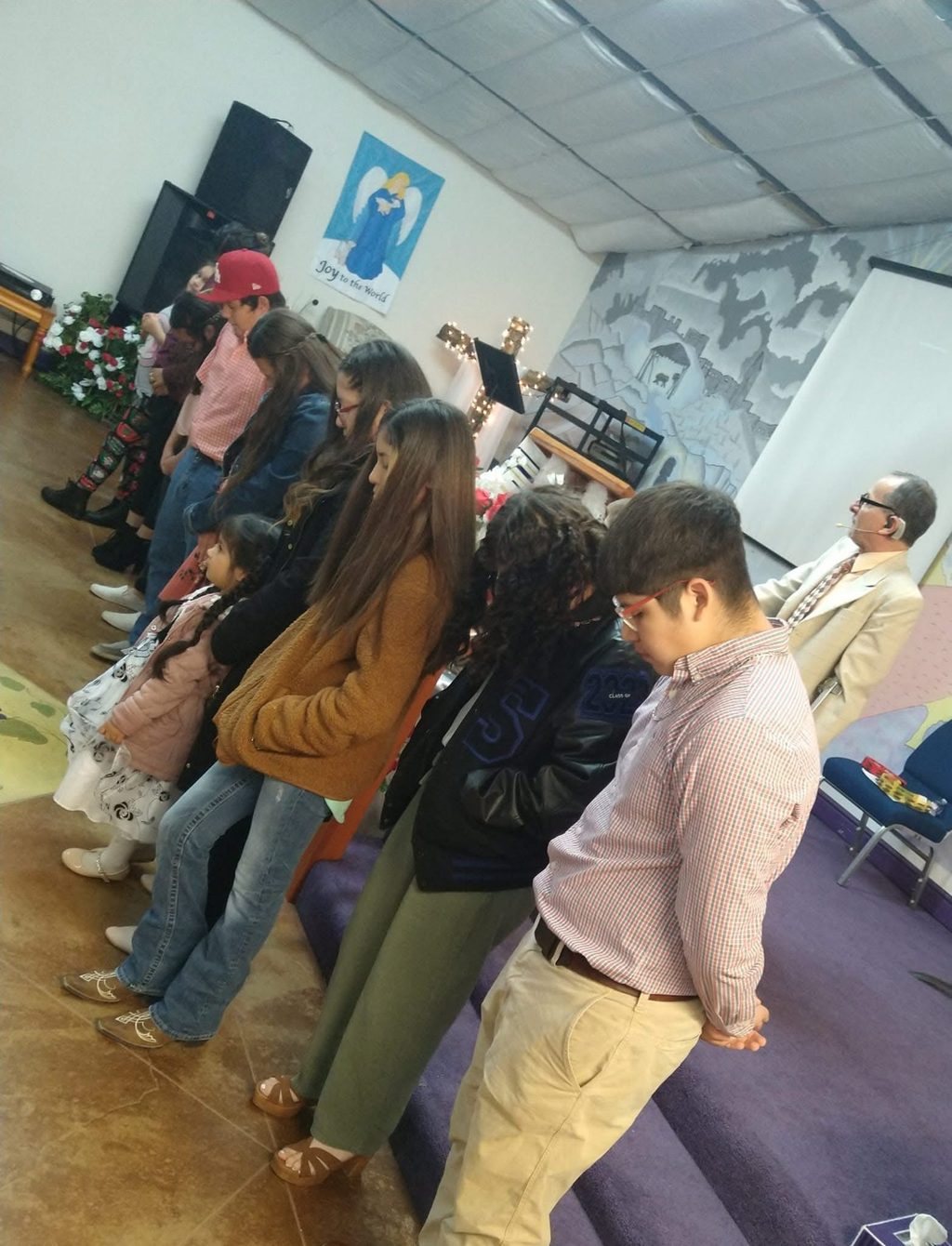 The congregation standing together in prayer