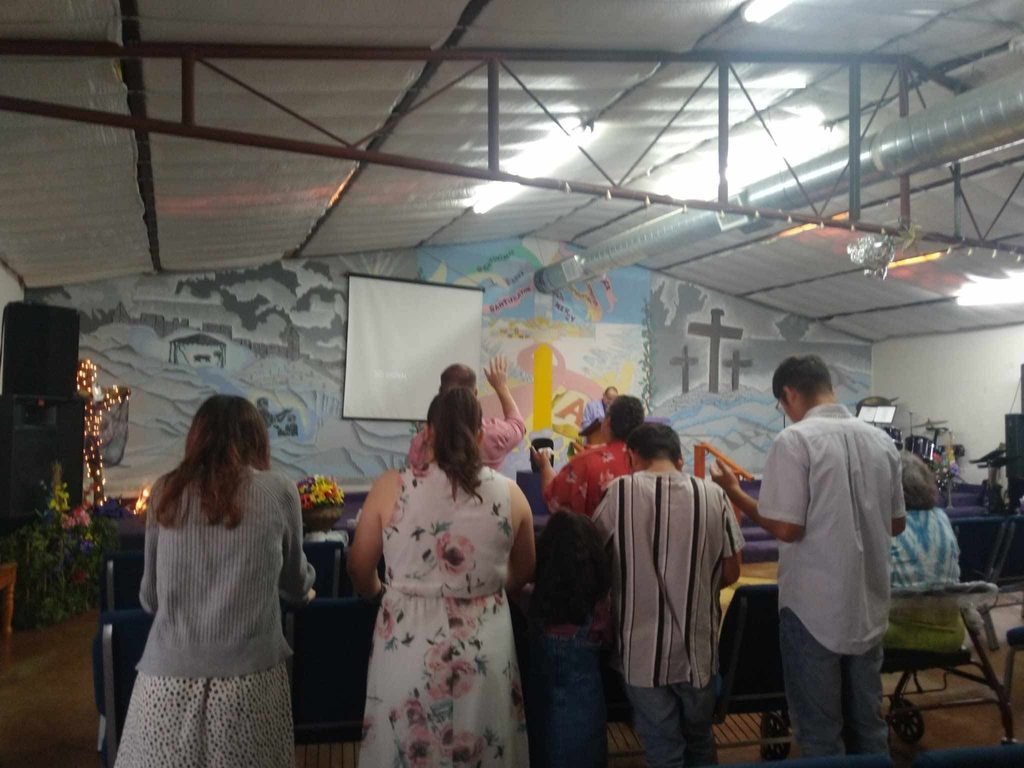 The congregation standing in worship during a service