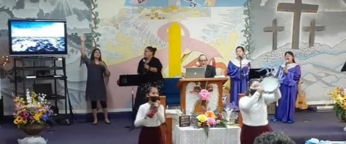 The worship team leading praise from the platform